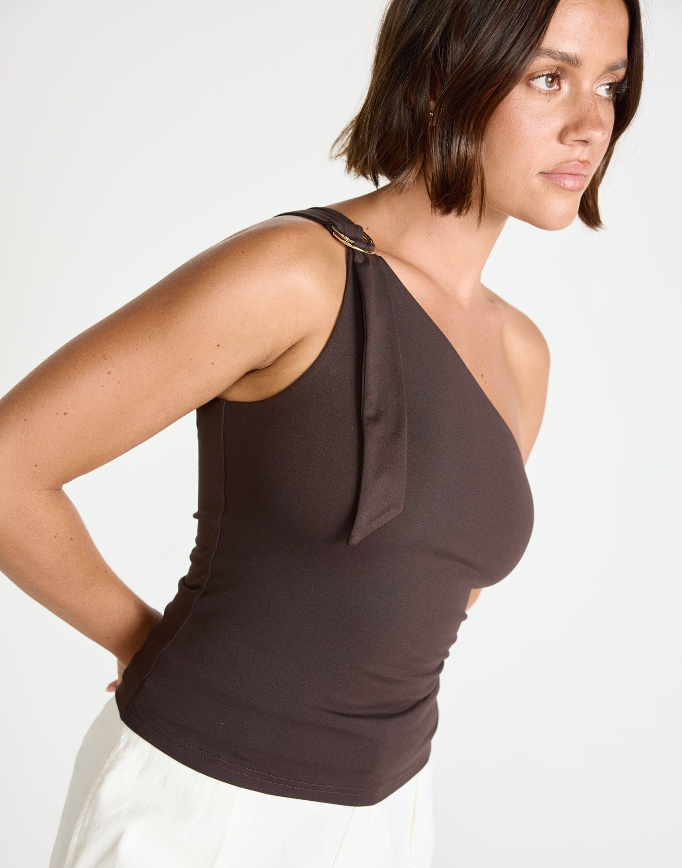Zuelia Top (Chocolate) | CHARCOAL Exclusive - Asymmetrical Neckline Top with Gold Embellishment - Women's Top - Charcoal Clothing